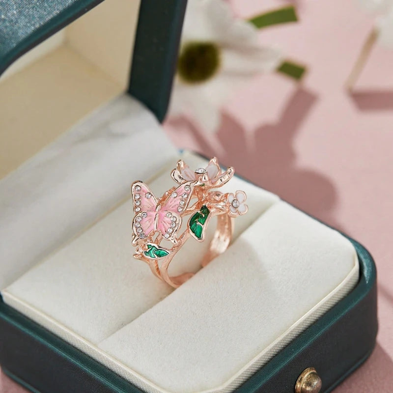 Anillo ajustable flor de cerezo y mariposa oro rosa