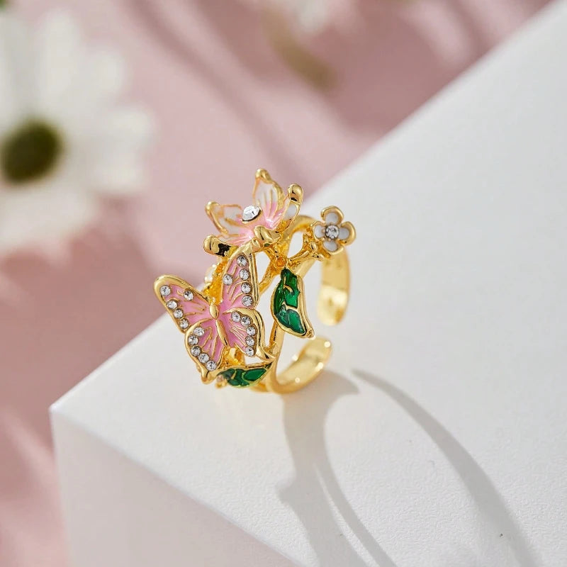 Anillo ajustable flor de cerezo y mariposa oro
