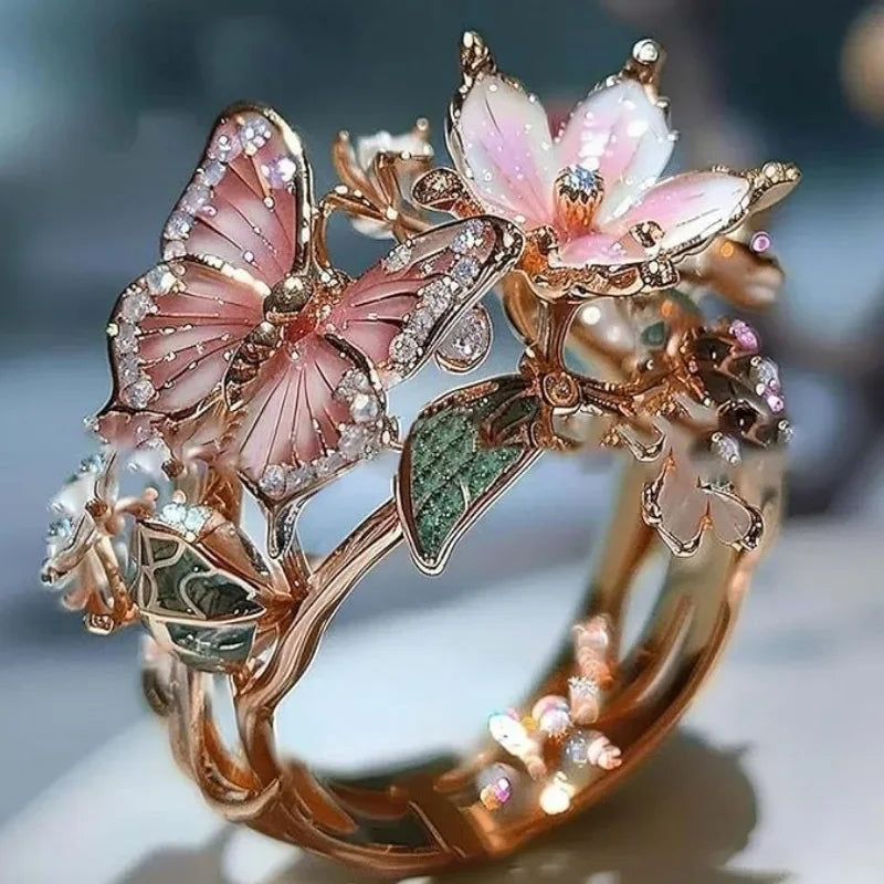 Anillo ajustable flor de cerezo y mariposa oro