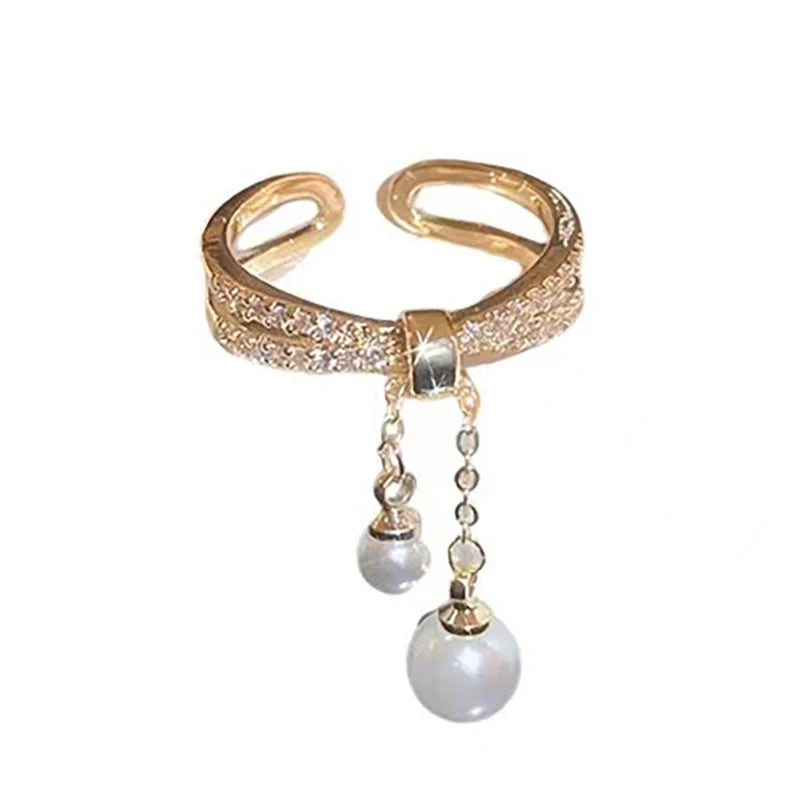 Anillo con perlas colgantes
