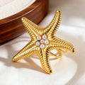 Anillo de concha y estrella de mar dorada