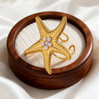 Anillo de concha y estrella de mar dorada