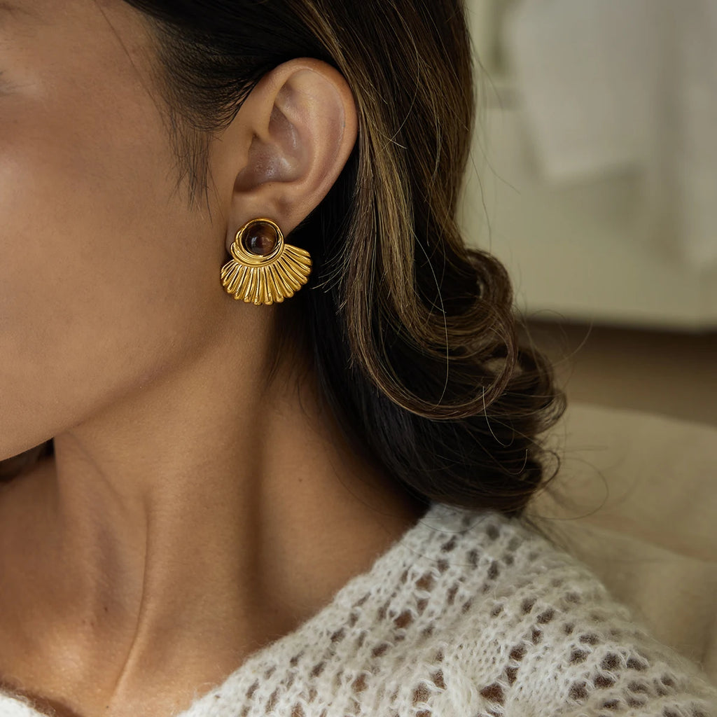 Gold shell earrings and tiger's eye stone