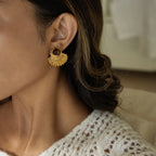 Gold shell earrings and tiger's eye stone