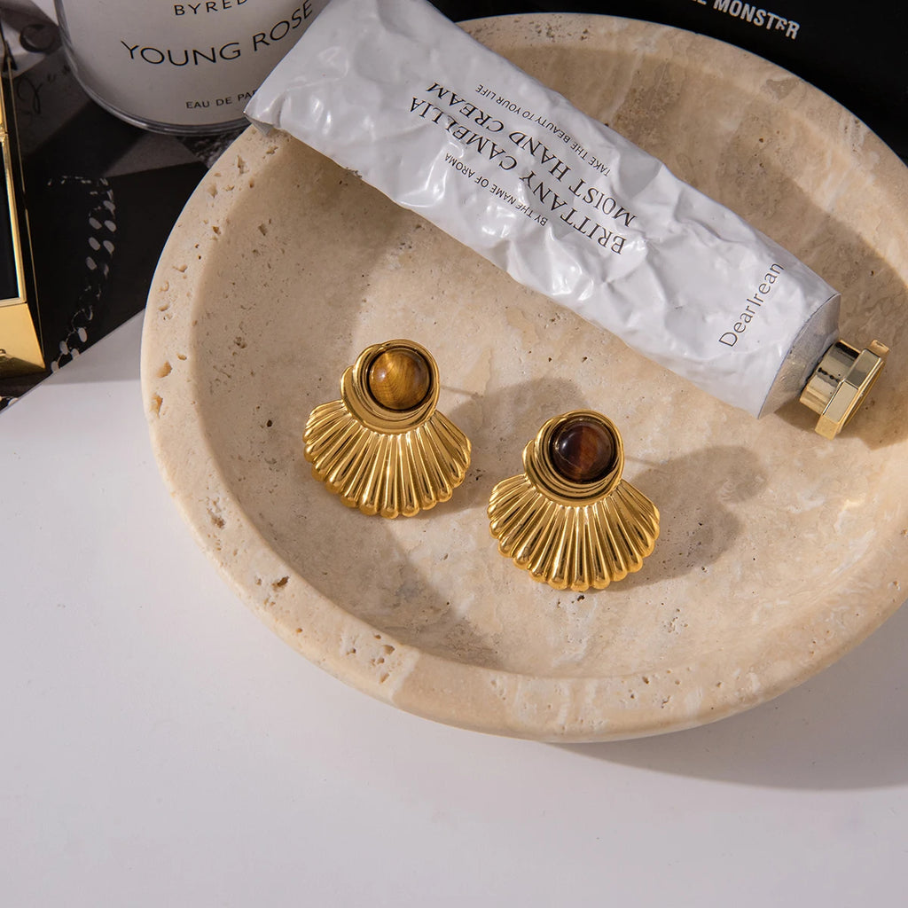 Gold shell earrings and tiger's eye stone