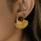 Gold shell earrings and tiger's eye stone