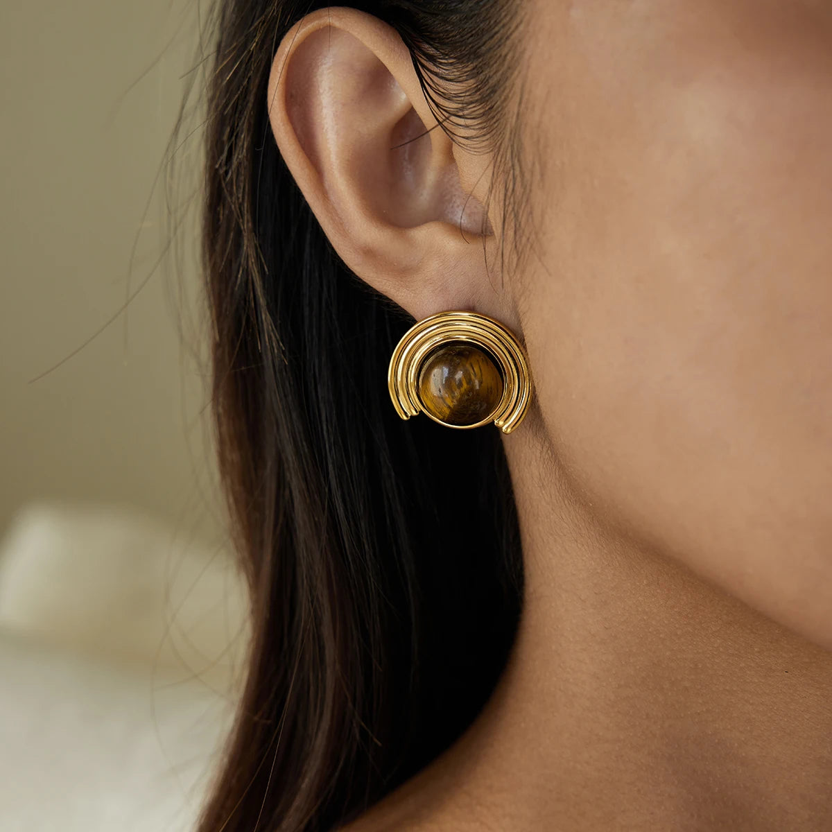Gold-tone crescent moon earrings in tiger's eye stone