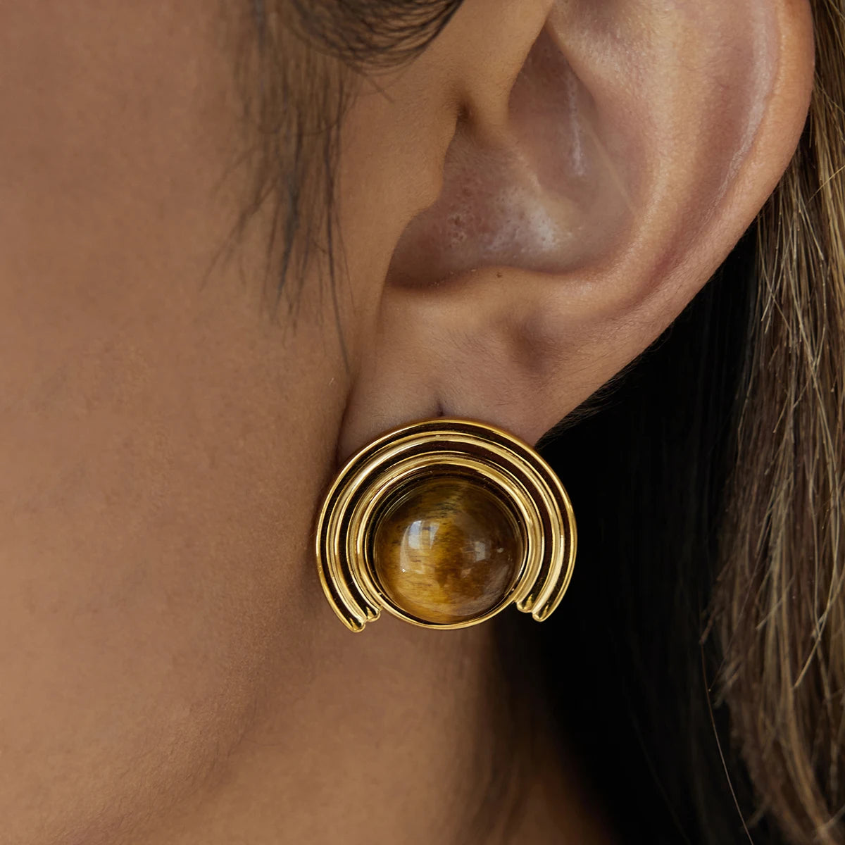 Gold-tone crescent moon earrings in tiger's eye stone