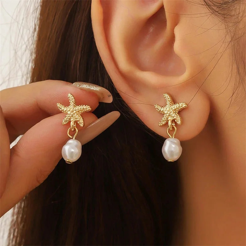 Pendientes dorados con concha, estrella de mar y perla