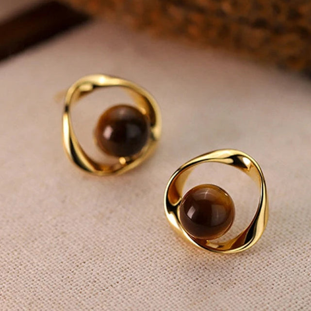 Gold wavy earrings with tiger's eye-effect beads