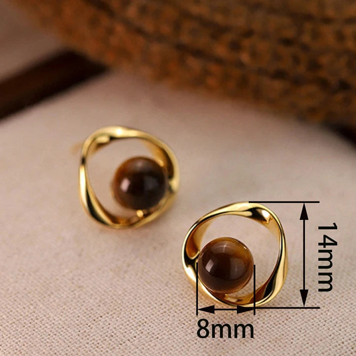 Gold wavy earrings with tiger's eye-effect beads