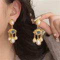 Pendientes Colgantes Ojo Azul y Perlas oro