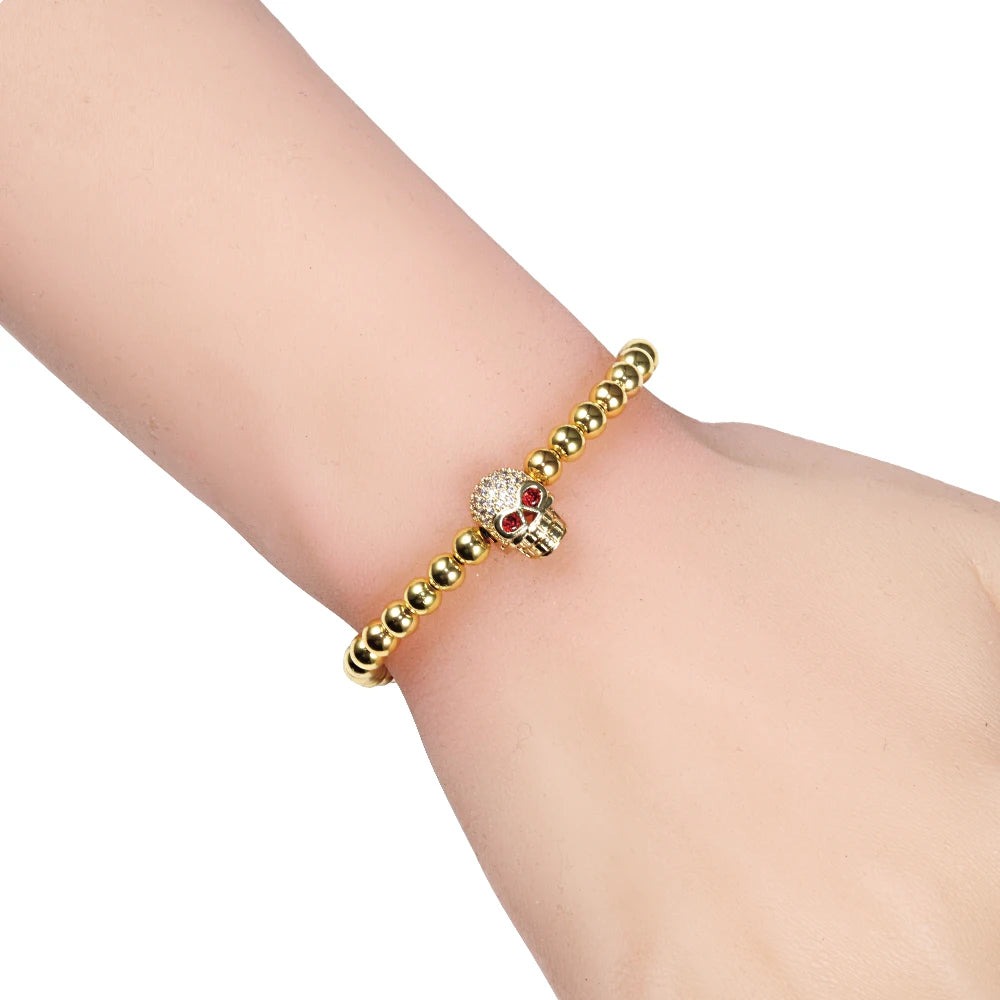 Beaded cord bracelet with mystical rhinestone skull in gold