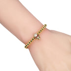Beaded cord bracelet with mystical rhinestone skull in gold