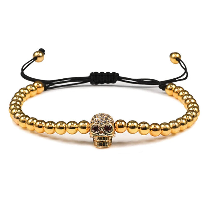 Beaded cord bracelet with mystical rhinestone skull in gold