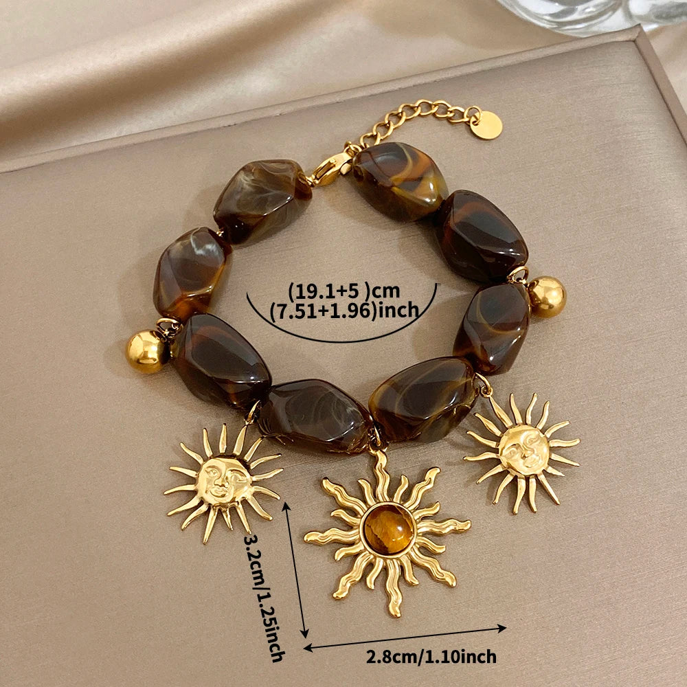 Bracelet bohème avec galets et pendentifs soleils effet oeil de tigre