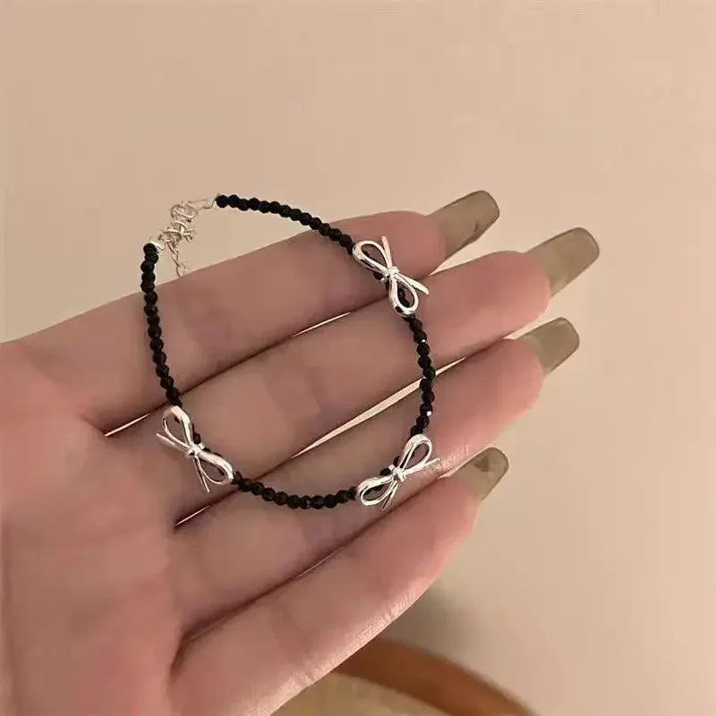 Pulsera con lazo de pajarita para mujer negro