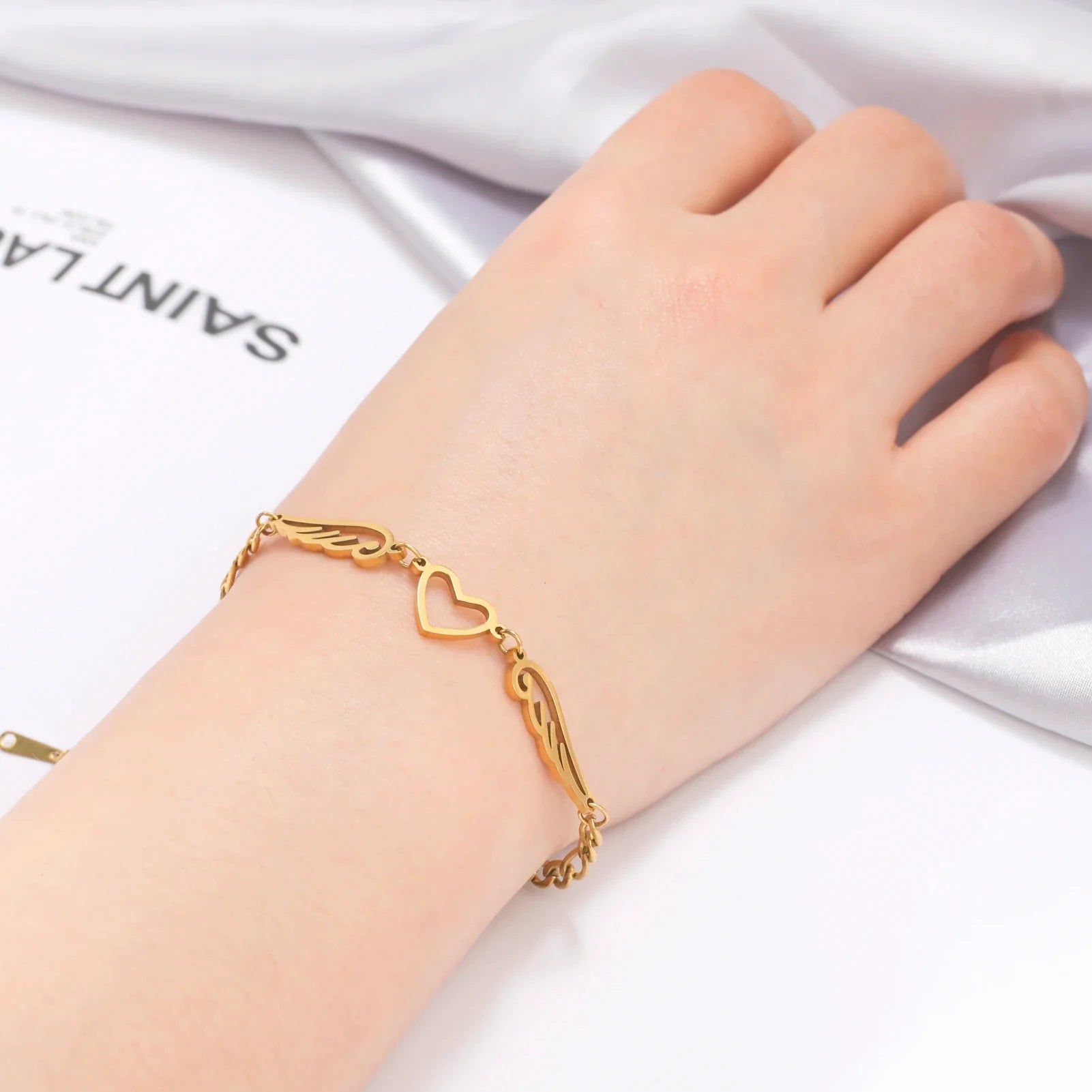Pulsera corazón y alas de ángel dorado
