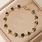 Pulsera de corazones esmaltados dorado y negro