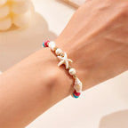 Pulsera de cordón con concha y estrella de mar roja estrella