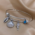 Pulsera de encanto con conchas plateada