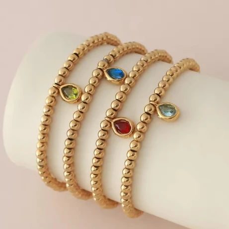 Pulsera dorada con piedra de nacimiento para mujer