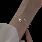 Pulsera de doble corazón y perlas