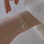 Pulsera de doble corazón y perlas