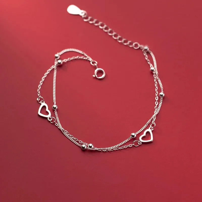Pulsera de doble corazón y perlas
