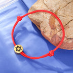 Pulsera de cuerda con el símbolo judío <span data-glossary-id="etoile-de-david">estrella de David</span> rojo y oro