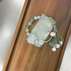 Pulsera de cuerda con cuentas y flor de loto