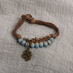 Pulsera de cuerda con trébol de 4 hojas y perlas azules