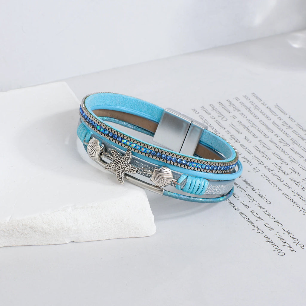 Pulsera de cuero con concha y estrella de mar azul