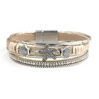 Pulsera de cuero con concha y estrella de mar en oro blanco