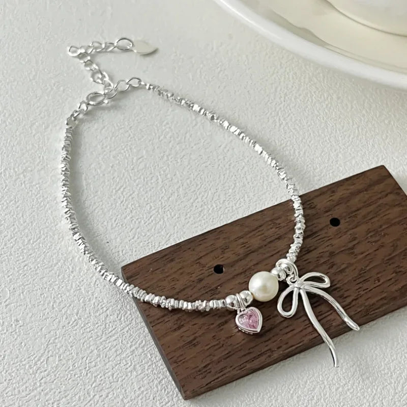 Pulsera Gourmette Nudo de Mariposa y Perla