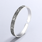 Open antique-style bracelet with engraved suns and crescent moons