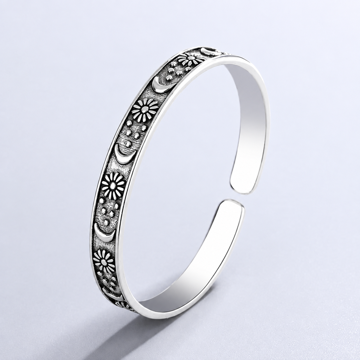 Open antique-style bracelet with engraved suns and crescent moons