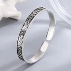 Open antique-style bracelet with engraved suns and crescent moons