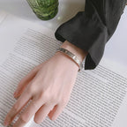 Open antique-style bracelet with engraved suns and crescent moons