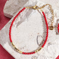 Pulsera roja y dorada coral