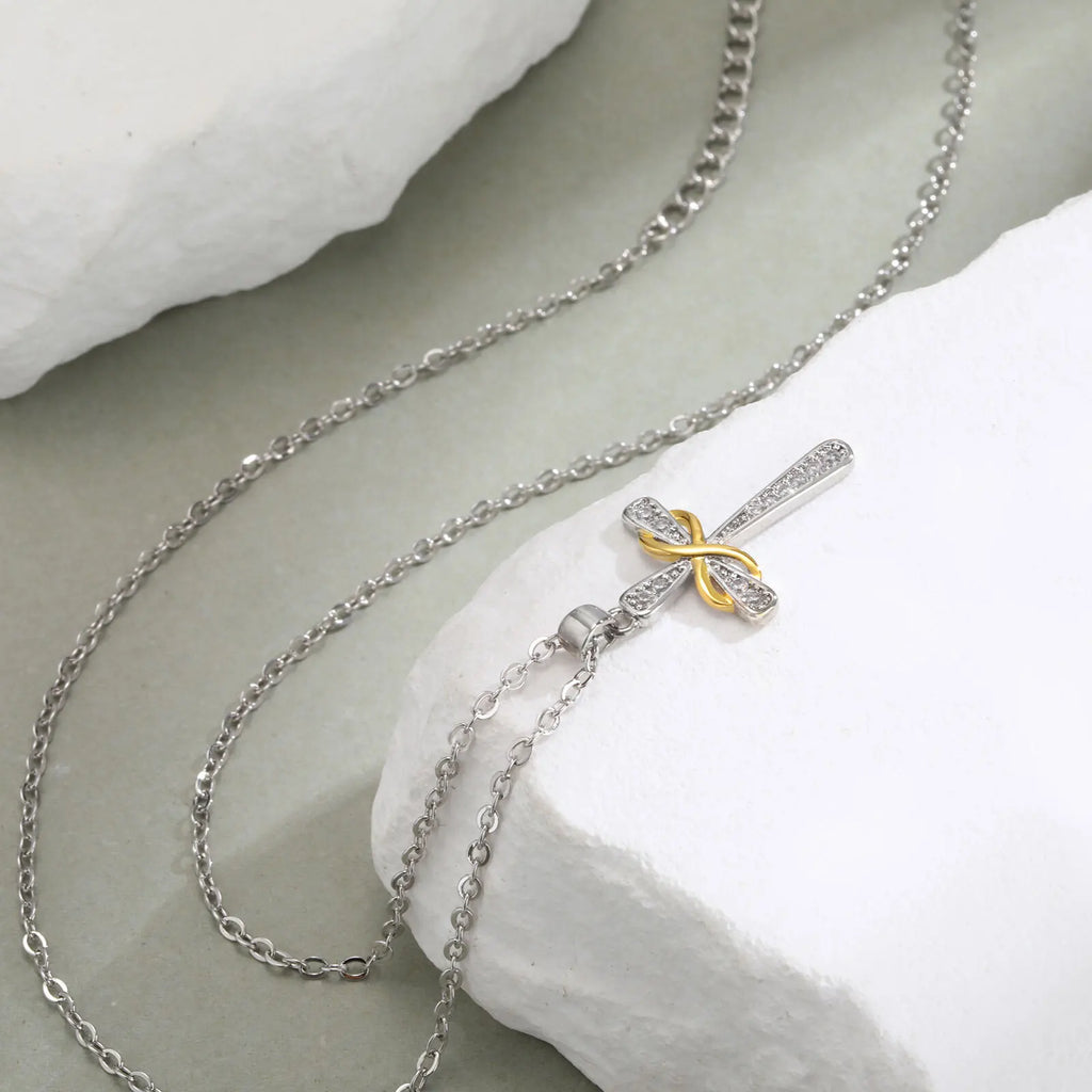 Necklace with two-tone cross and infinity symbol pendant