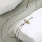 Necklace with two-tone cross and infinity symbol pendant