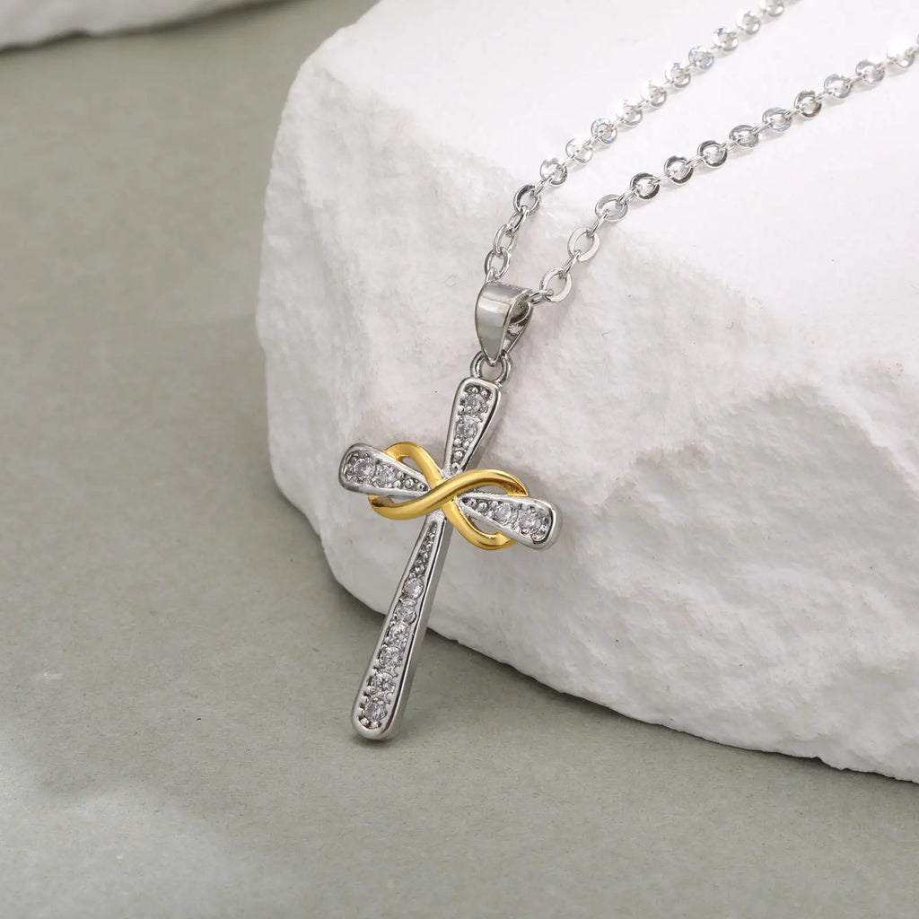 Necklace with two-tone cross and infinity symbol pendant