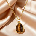 Necklace with geometric pendant and tiger's eye stone