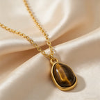 Necklace with geometric pendant and tiger's eye stone