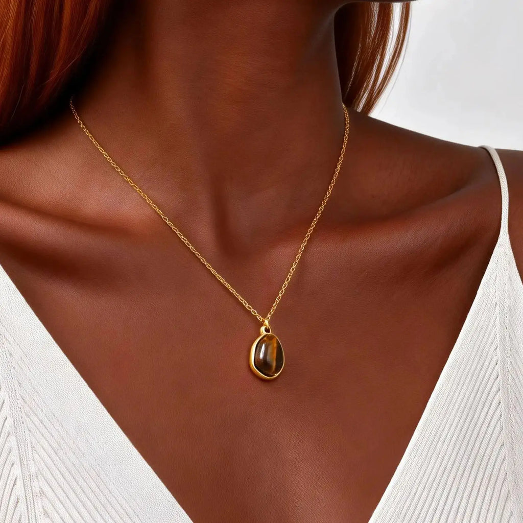 Necklace with geometric pendant and tiger's eye stone