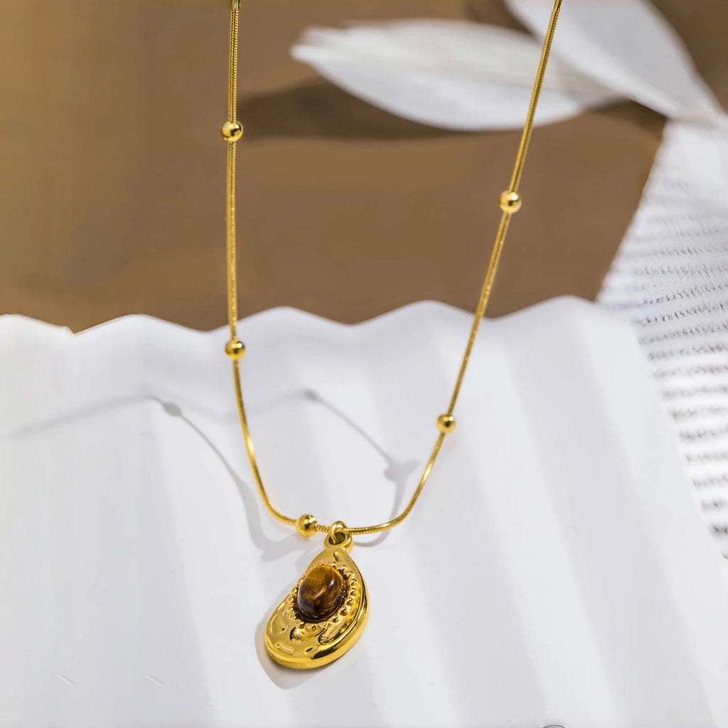 Necklace with teardrop pendant in natural tiger's eye stone