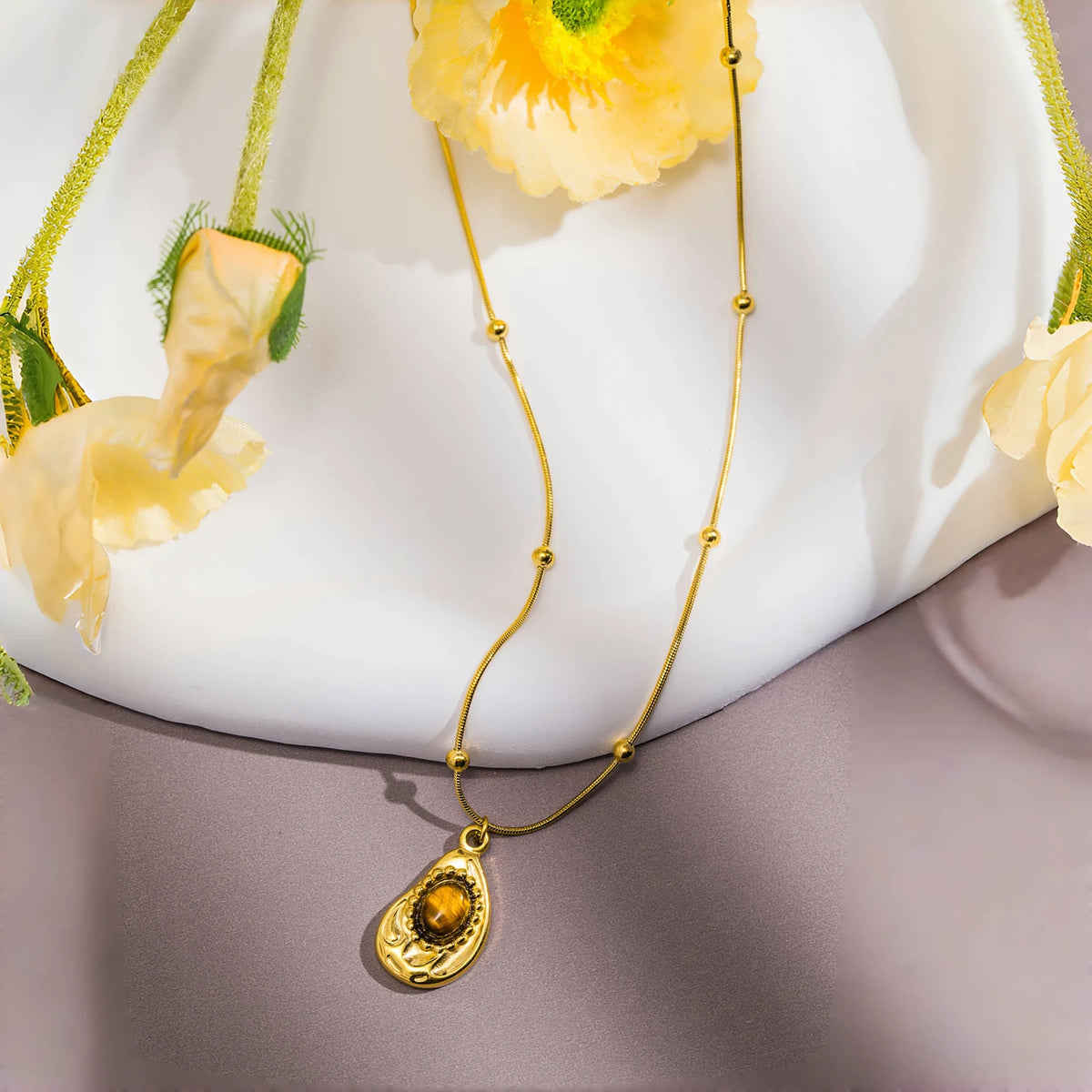 Necklace with teardrop pendant in natural tiger's eye stone