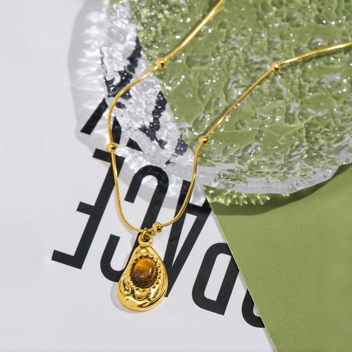 Necklace with teardrop pendant in natural tiger's eye stone