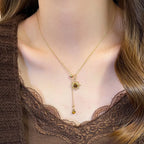 Tie necklace with sunburst charms and tiger's eye stones